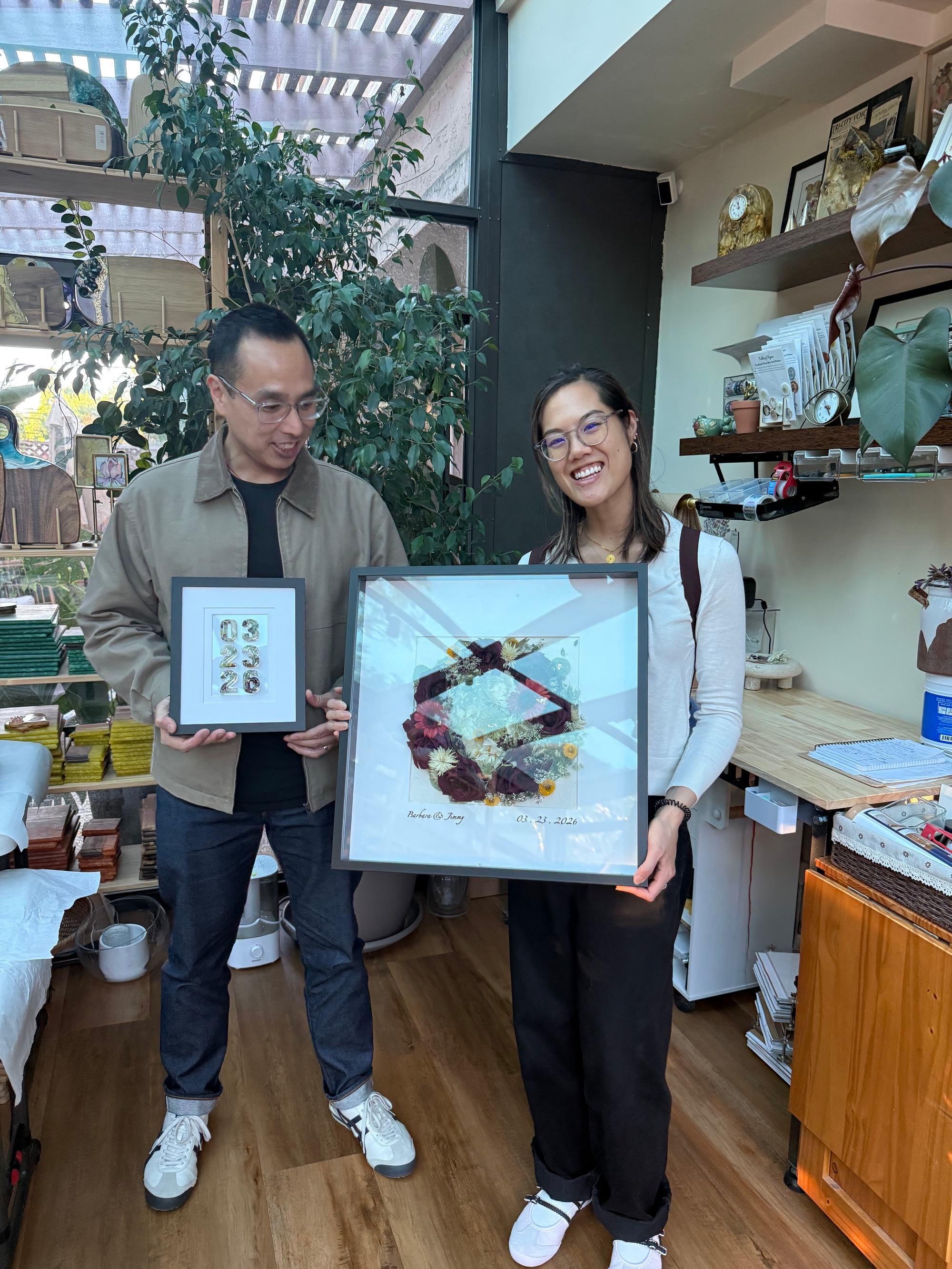 Couple collecting their custom wedding flower frames