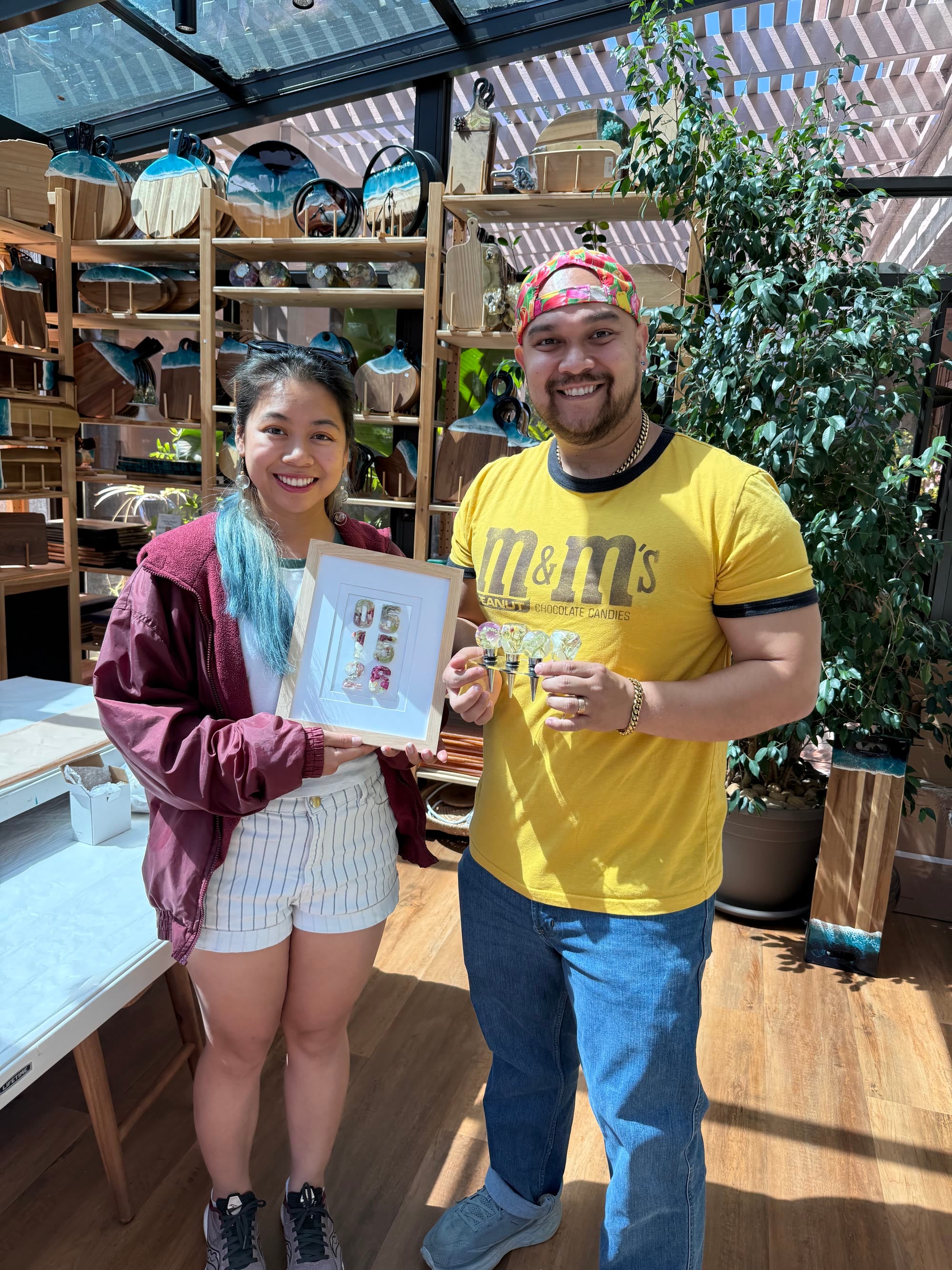 Couple collecting framed flower art and resin wine stoppers