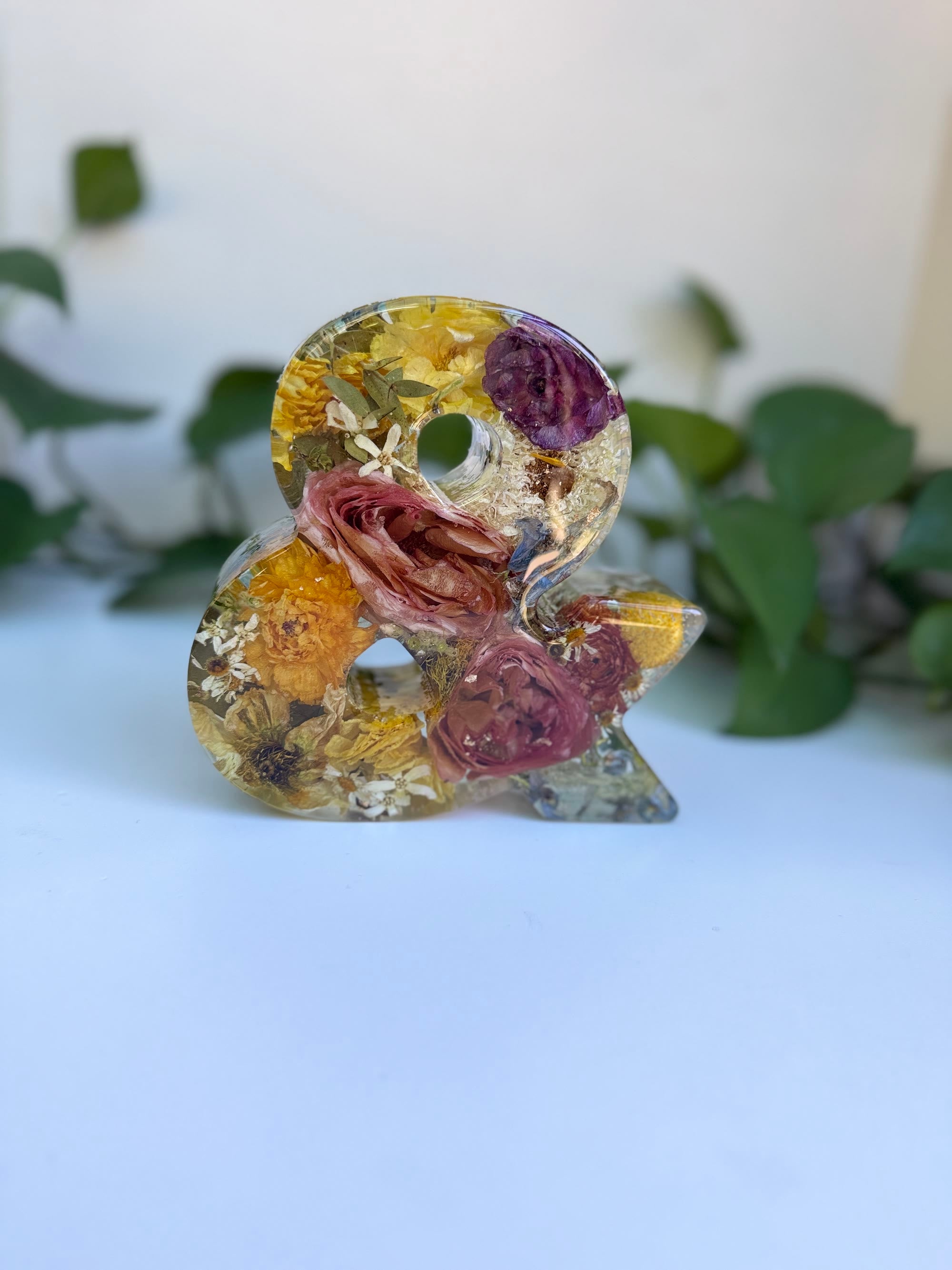 Wedding flowers preserved in a resin ampersand